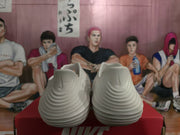 Rear view of white slip-on clogs showing sculpted ridged heels