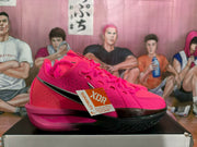 Side profile of a bright pink Nike basketball shoe with a black outsole and a visible product tag.
