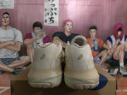 Rear view of the cream and taupe basketball shoes with heel logos