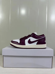 Side profile of the burgundy and white low-top sneaker showing the contrasting Swoosh and light midsole.