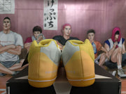 Rear view of yellow Converse sneakers showing the heel branding and white outsole stripe.