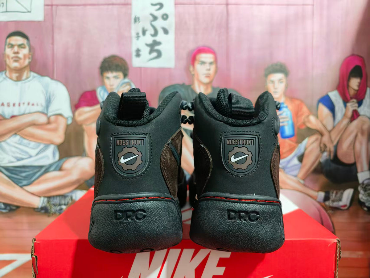 Rear view of black and brown high-top sneakers showing padded collars, heel branding details, textured heels, and a Nike shoebox.