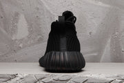 Rear view showing the heel pull tab, textured upper, and ribbed heel section.