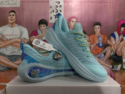 Angled view of the paired light blue basketball sneakers displaying the laces, side panels, outsole, and attached emblem tag.