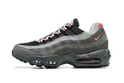 Side profile of a Nike Air Max 95 TT sneaker in grey, black, and red