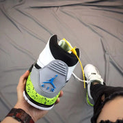 Rear view showing the gray heel panel and bright green accent