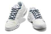 Front view of a pair of white sneakers with navy laces