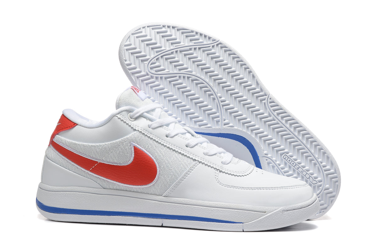 White low-top Nike Book 1 shoe with red Swoosh and blue outsole accent, shown with outsole