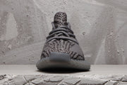 Front view showing the patterned knit-style upper, laces and rounded toe.