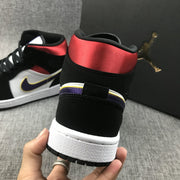 Close-up of the rear heel showing the red collar, black heel panel, and white midsole.