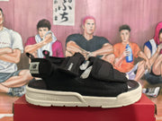 Side profile of a black New Balance sandal showing the open toe, adjustable upper straps, heel label, and branded sole sidewall.
