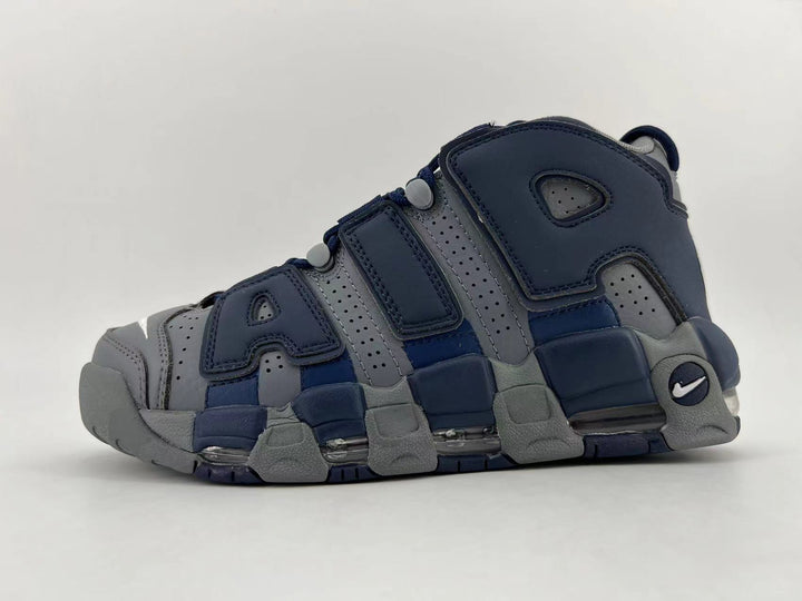 Side view of a navy and grey Nike Air More Uptempo sneaker with oversized AIR lettering and a segmented sole.