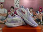 Angled view of the pair showing the white and light purple colorway with red branding details.
