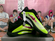 Side view of green and black Nike basketball sneakers with pink swooshes, layered panels, and black outsoles.