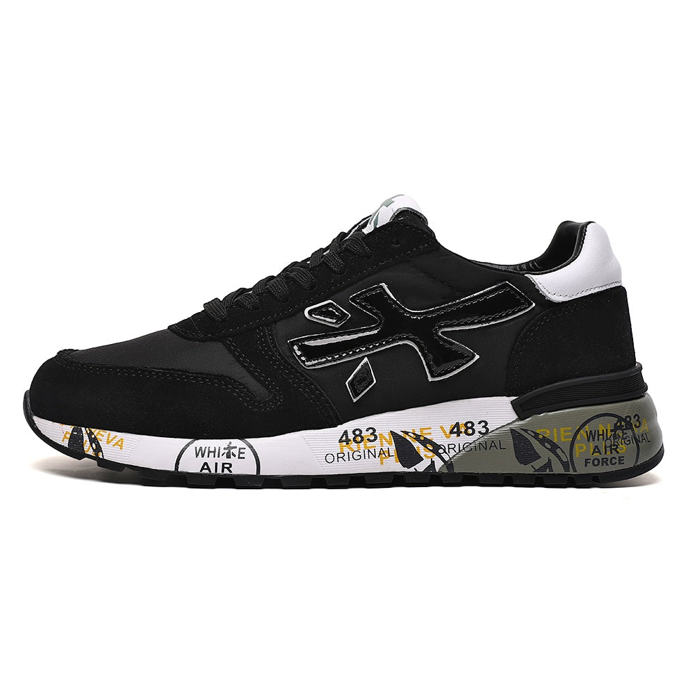 Side view of a black low-top sneaker with a large outlined side emblem, white heel accent, and printed graphics on the midsole.