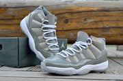 Pair of gray and white high-top sneakers shown at an angled outdoor display.