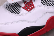Close-up of white stitched upper panels, black midsole detail, and red outsole trim.