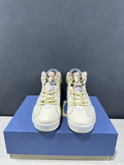 Front view showing the high-top shape, cream laces, stitched panels, and padded tongues.