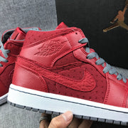 Close side view showing the embossed side branding, red panels, and gray laces.