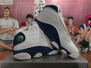 Pair of white, grey, and navy Jordan basketball shoes shown at an angle.