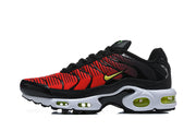 Side view of a red and black Nike Air Max Plus sneaker with a white midsole and yellow-green accents.