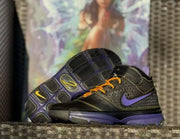 Side profile with the outsole visible, showing black tread sections and a purple midsole.