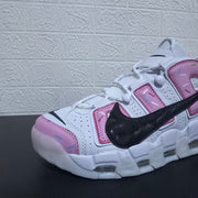 Close-up of the pink toe panel, lace area, perforations, and black Swoosh.