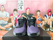 Front view of purple basketball shoes with black laces and tongue logos