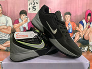 Angled view of the black and grey Nike sneakers displayed together, showing the side branding, lace-up construction, and contrasting sole.