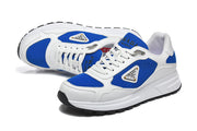 Pair of white and blue low-top lace-up sneakers in a three-quarter view.