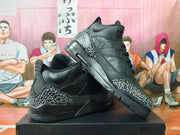 Pair of black high-top Jordan sneakers with gray elephant-print overlays, shown from the side and at an angle