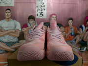 Front view of pink ASICS basketball sneakers showing the lace-up construction, tongues and patterned toe outsoles.