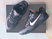 Top and side views of charcoal Kobe 11 shoes with pink details and Kobe tongue logos.