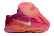 Side view of pink and purple Nike GT Hustle 3 with coral panels and translucent outsole accents.