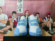 Front view of white and blue high-top Jordan sneakers with blue laces.
