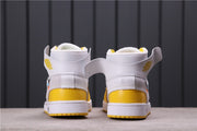 Rear view showing white ankle collars, yellow heel panels, and white midsoles.
