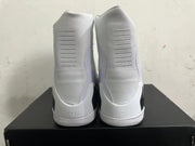 Rear view of white high-top basketball shoes with ribbed heel details and Kobe emblems.