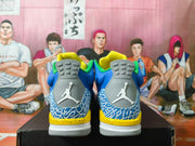Rear view of blue Jordan 3 sneakers with gray heel tabs