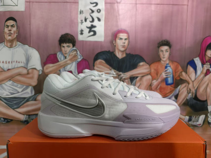 Side view of a white and pale purple Nike basketball sneaker displayed on an orange shoebox.