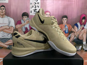 Beige and black Nike basketball shoes with white outsoles, shown from the side