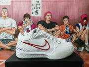 Side profile showing the white upper, red Nike swoosh, padded collar, and textured outsole.