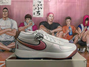 Side view showing a pink Nike Swoosh with black outline on a white sneaker.