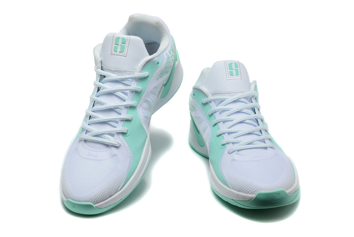 Pair of white and mint-green Nike Sabrina basketball shoes shown from the front