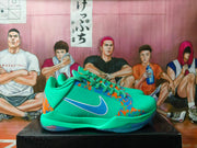 Side view of green Nike basketball shoes with blue and orange graphics and a contrasting Swoosh.