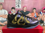 Side profile of a black basketball sneaker with purple panels, gold graphic detailing and a translucent-looking outsole.