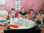 Side profile of a white Jordan sneaker with gray textured panels, white laces, and orange-red heel and midsole accents.