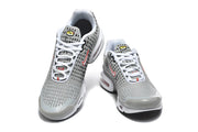 Front view of grey Nike Air Max Plus VIII sneakers with white laces and patterned uppers.