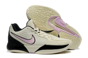 Pair of sneakers displayed with one outsole facing upward, showing the patterned traction surface