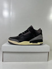 Side profile showing the black upper, gray heel and toe overlays, cream midsole, and heel cushioning window.