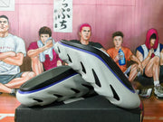 Pair of gray slip-on shoes with black and blue accents, shown from below.